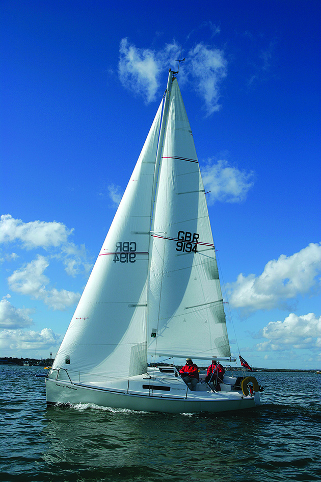 A yacht will full sails cruising along the ocean