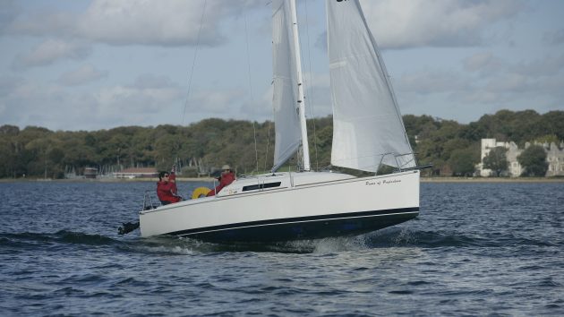 Two sailors in a yacht sailing with apparent wind