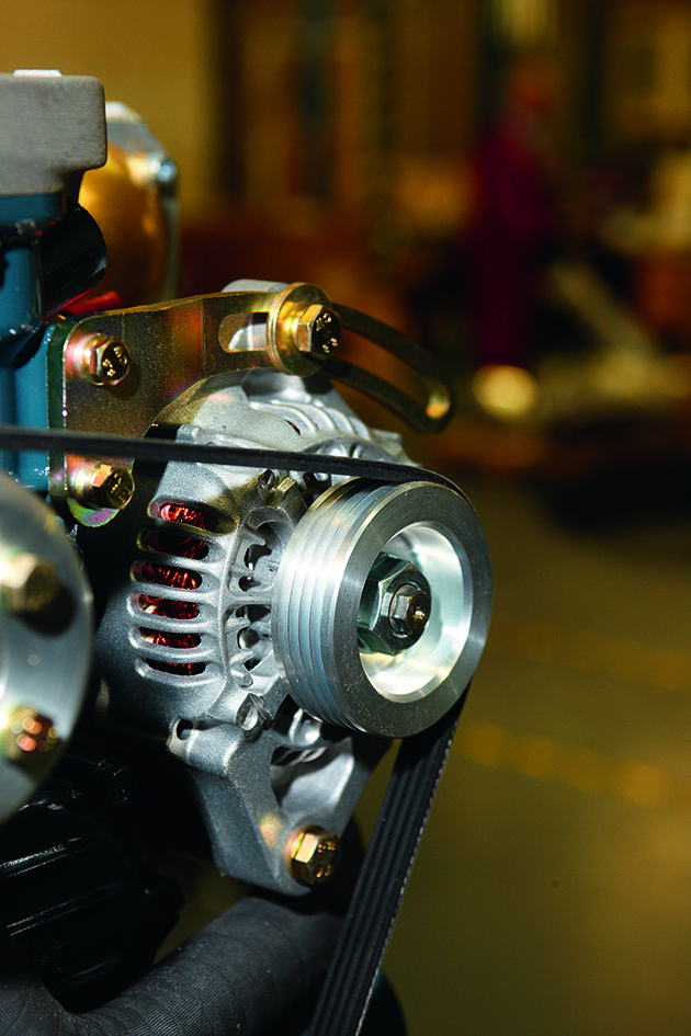 An alterntior with a belt in a boat engine