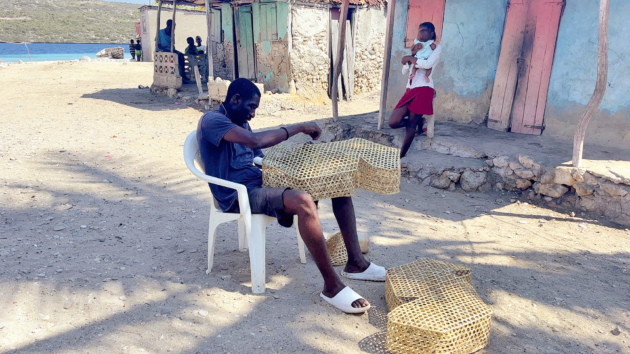 Fisherman weaving traps.